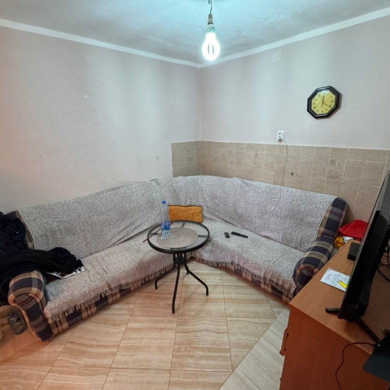 Modern, inviting Ulcinj living space: corner sofa, glass table, stylish d&eacute;cor&mdash;ideal Montenegro real estate. eksosphere doo project.