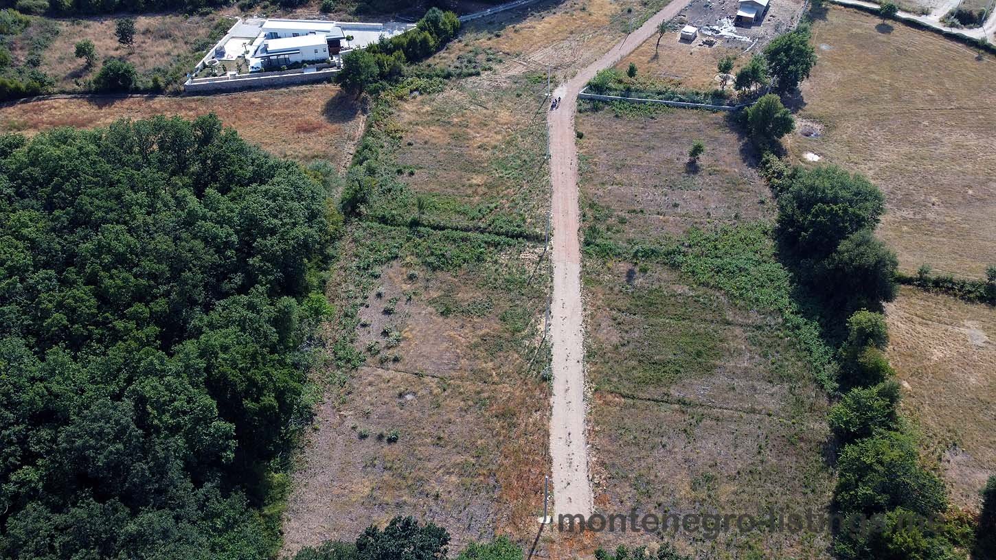 Aerial view of Ulcinj, Montenegro real estate&mdash;lush fields, scenic road, investment properties. By ekosphere doo on immorenta.me.
