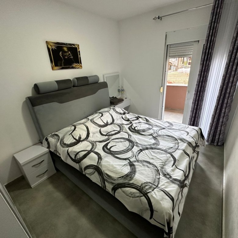 Modern Ulcinj bedroom: double bed, chic d&eacute;cor, balcony access. Ideal Montenegro real estate&mdash;exclusive via immorenta.me by ekosphere doo.