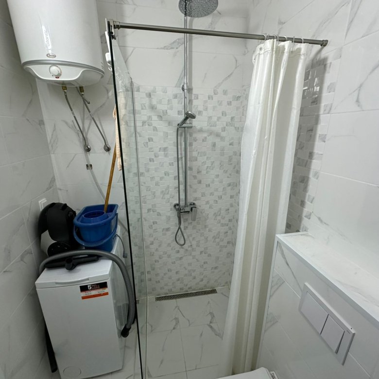 Modern, fully equipped bathroom in Ulcinj property&mdash;shower, washer, water heater, sleek tile. Invest with immorenta.me/Ekosphere DOO.