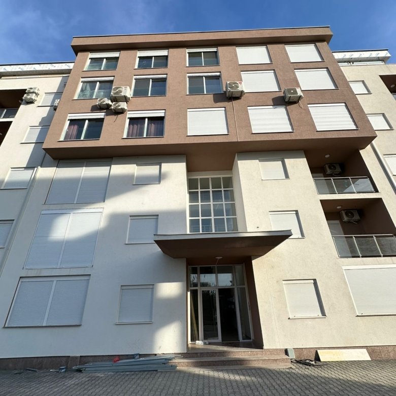 Modern multi-story residence in Ulcinj with elegant facade, AC units, and glass entry&mdash;prime investment on immorenta.me by ekosphere doo.