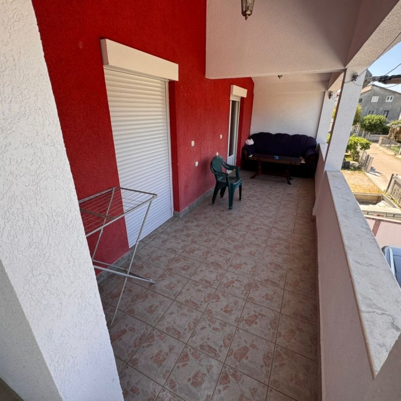 Spacious tiled balcony in Ulcinj with stylish seating, city views&acirc;prime investment via immorenta.me by Ekosphere doo.
