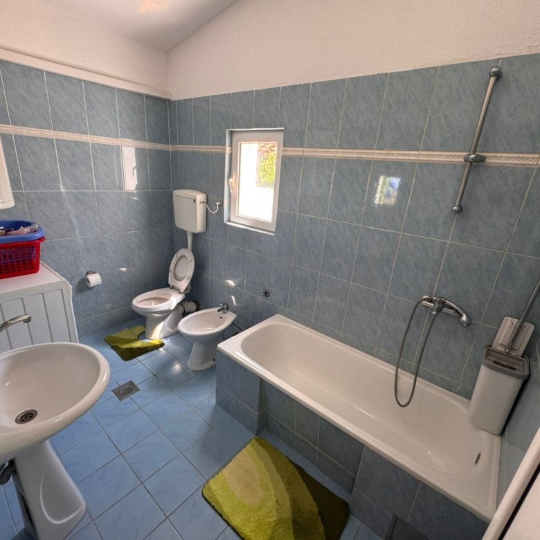Modern bathroom in Ulcinj, Montenegro: blue tile, tub, bidet, washer & window. Smart investment&acirc;find it on immorenta.me by ekosphere doo.