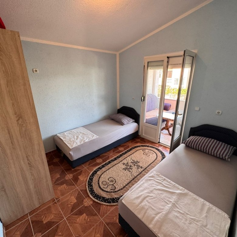 Charming Ulcinj bedroom&acirc;two single beds, modern wardrobe, patio access. Ideal Montenegro investment. Eksphere doo via immorenta.me.