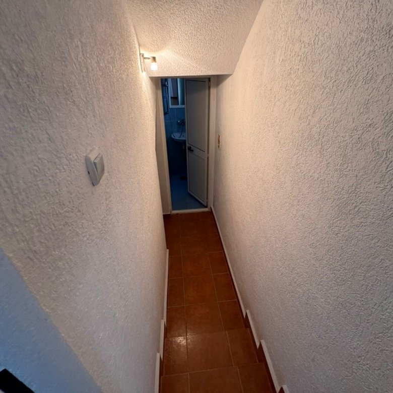 Inviting hallway with textured white walls, tiled floor, and modern lighting&acirc;prime Ulcinj real estate from immorenta.me by ekosphere doo.