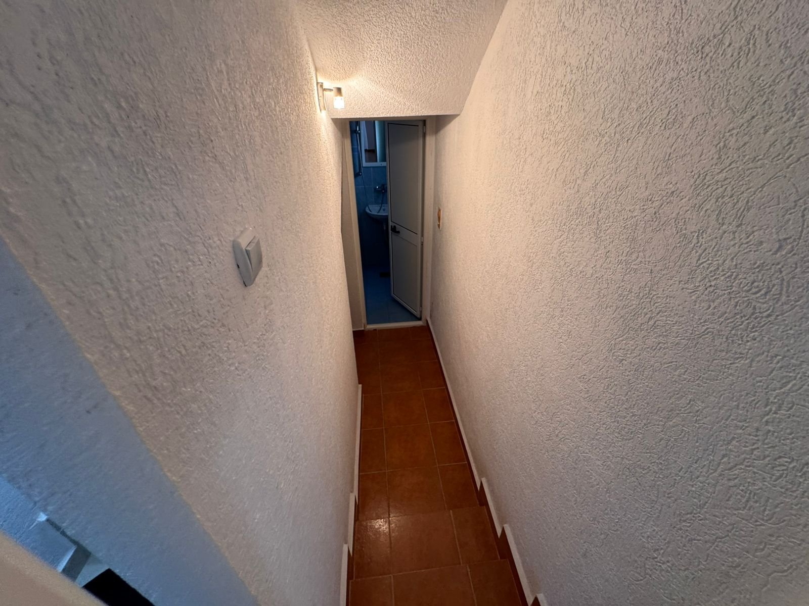 Inviting hallway with textured white walls, tiled floor, and modern lighting&acirc;prime Ulcinj real estate from immorenta.me by ekosphere doo.