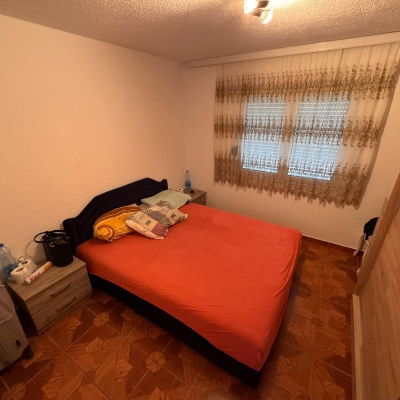 Charming Ulcinj bedroom with double bed, bright linens, and wood wardrobe&acirc;ideal Montenegro investment via immorenta.me/Ekosphere.