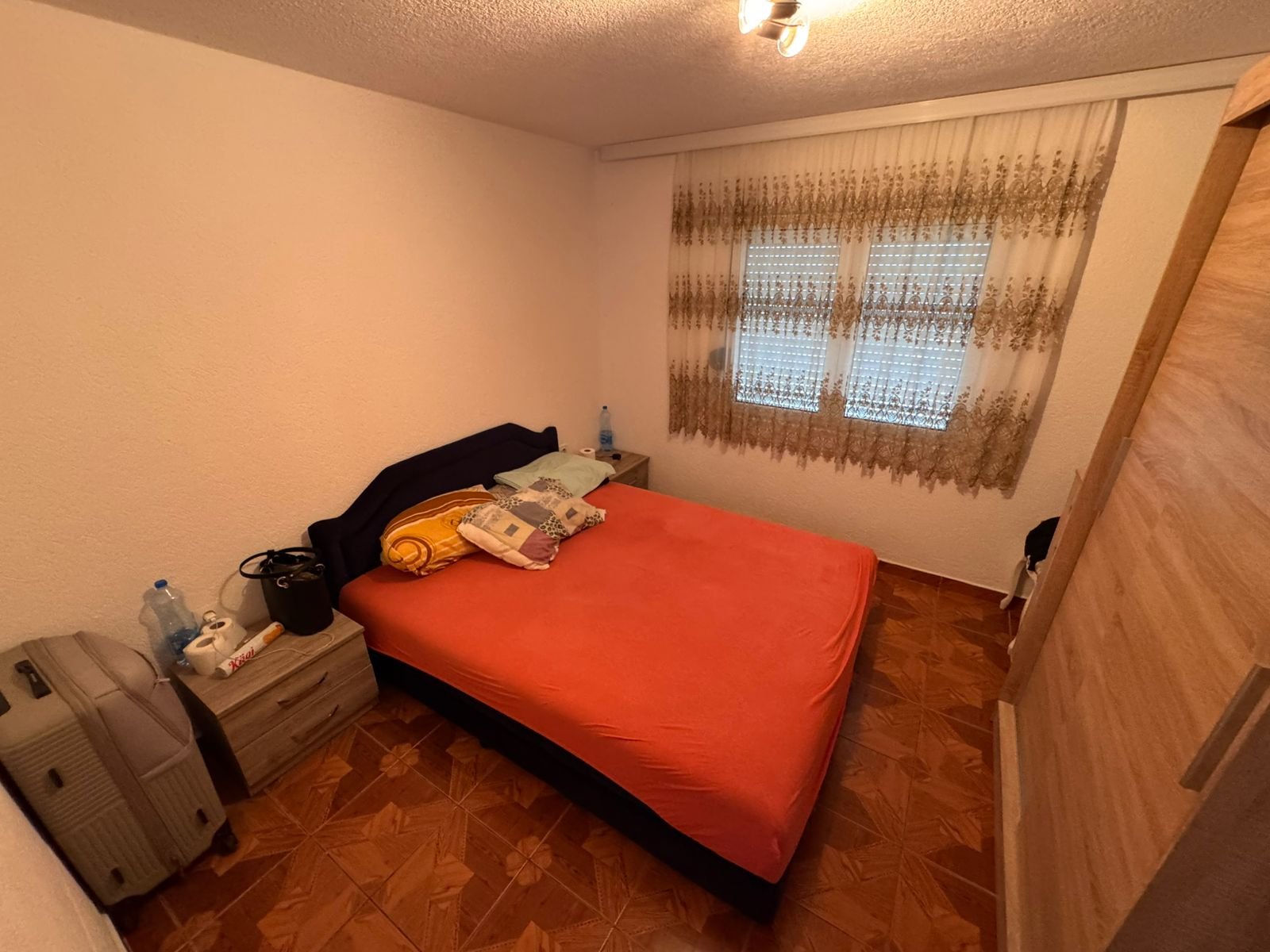 Charming Ulcinj bedroom with double bed, bright linens, and wood wardrobe&acirc;ideal Montenegro investment via immorenta.me/Ekosphere.