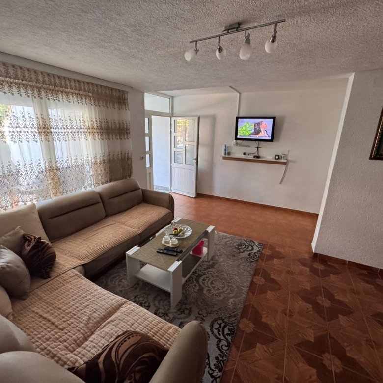 Elegant Ulcinj living room with beige sectional, chic decor, and modern TV&acirc;exclusive on immorenta.me by Ekosphere doo.