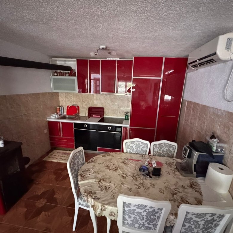 Modern kitchen in Ulcinj with red cabinets, oven, AC, dining set&acirc;ideal Montenegro real estate from Ekosphere on immorenta.me.