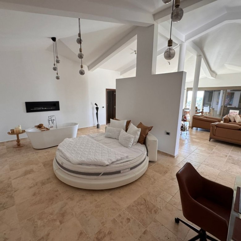 Discover luxury Ulcinj real estate: round bed, elegant decor, fireplace, marble floors&mdash;exclusive from immorenta.me by ekosphere doo.
