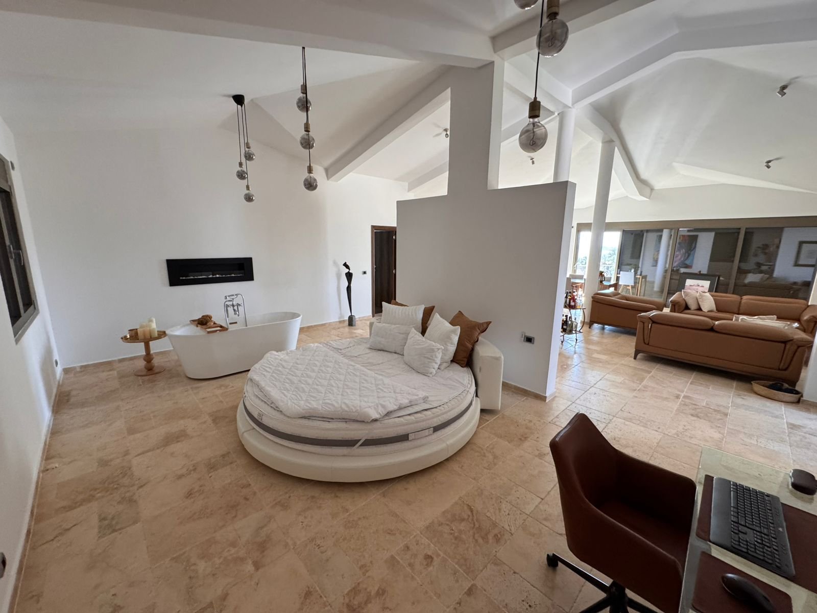 Discover luxury Ulcinj real estate: round bed, elegant decor, fireplace, marble floors&mdash;exclusive from immorenta.me by ekosphere doo.