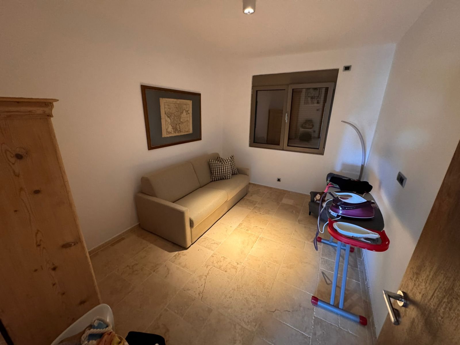 Charming Ulcinj apartment: tiled floor, bright sofa, map d&eacute;cor&mdash;ideal Montenegro investment. Listed on immorenta.me by ekosphere doo.