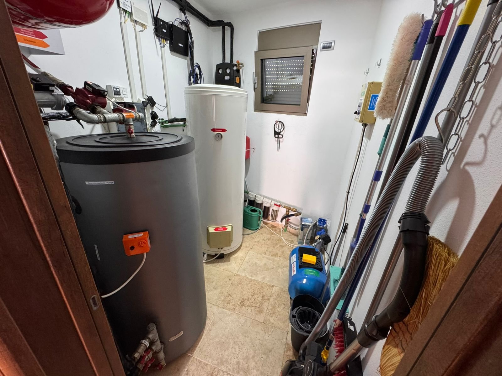 Spacious Ulcinj utility room with dual water heaters, premium fittings, tiled floors&mdash;ideal investment. Exclusive at immorenta.me by ekosphere doo.