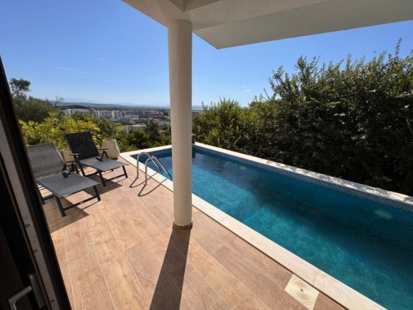 Luxury Ulcinj property: pool, deck, lush landscape, city and mountain views. Invest with Ekosphere at immorenta.me today.