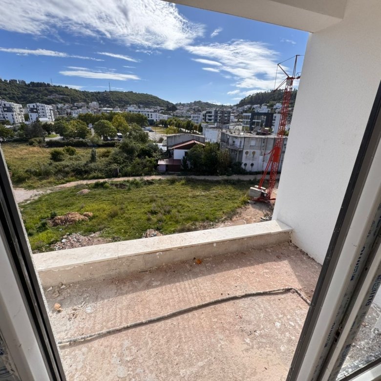 Stunning Ulcinj property view: modern buildings, lush spaces, hills, and new investment projects by Ekosphere on immorenta.me.