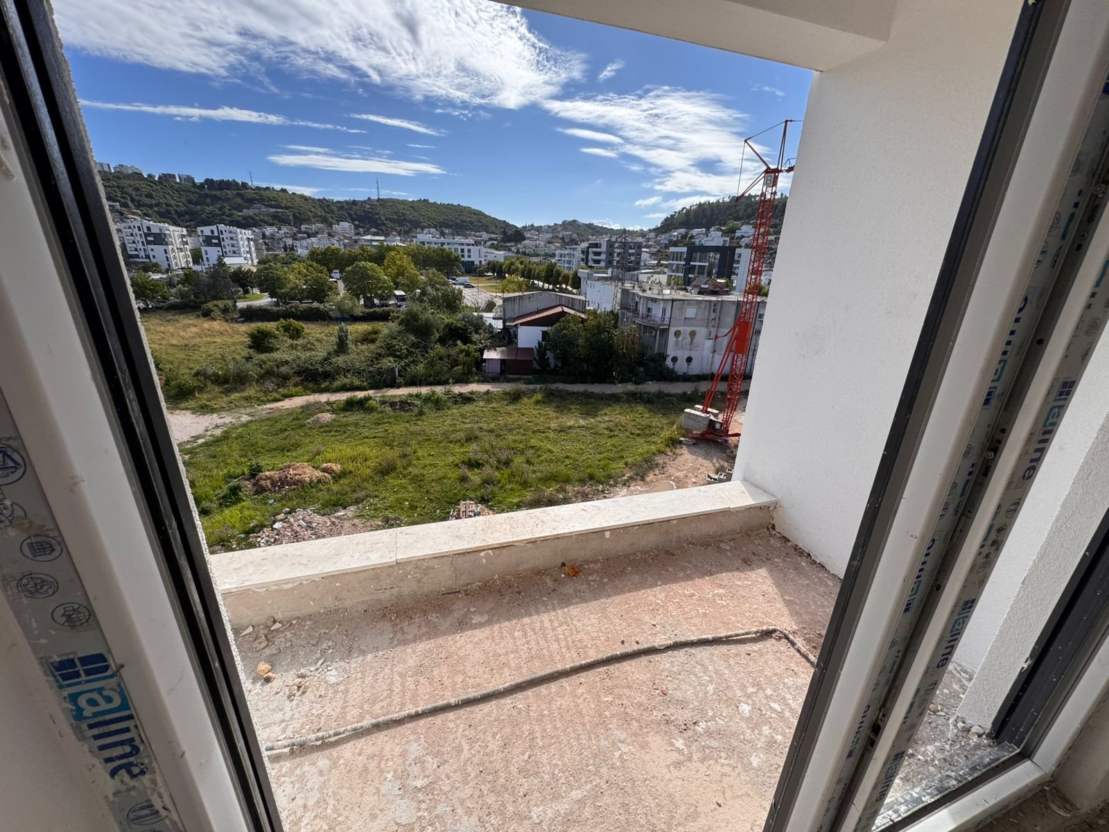 Stunning Ulcinj property view: modern buildings, lush spaces, hills, and new investment projects by Ekosphere on immorenta.me.