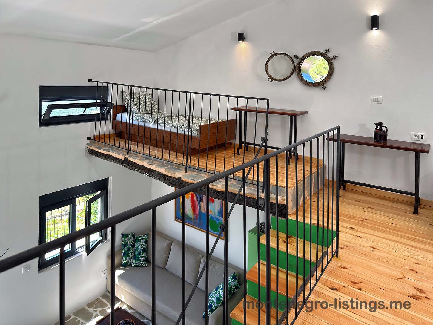 Modern loft bedroom with wood floors, metal railing, and dual mirrors, ideal Ulcinj investment at immorenta.me by ekosphere doo.