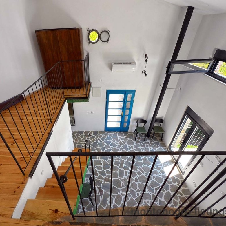Listings for Sale - Modern open-concept living area in Ulcinj with wood stairs, stone flooring, large windows. Top Montenegro investment&mdash;immorenta.me by ekosphere doo.