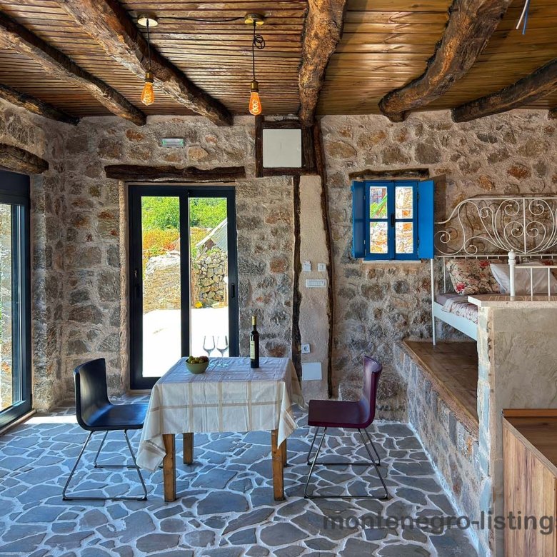 Discover a charming Ulcinj stone-walled home with tiled floors, wood beams, and inviting dining&mdash;an ideal Montenegro investment via ekosphere doo.