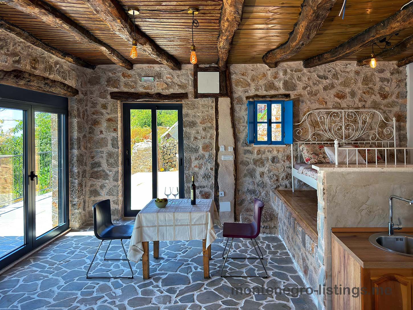 Discover a charming Ulcinj stone-walled home with tiled floors, wood beams, and inviting dining&mdash;an ideal Montenegro investment via ekosphere doo.