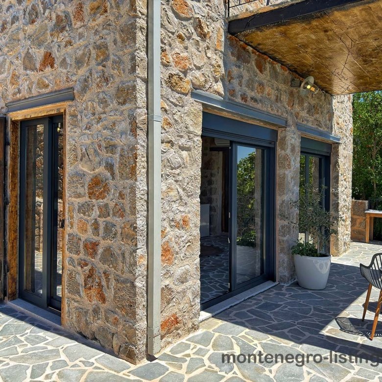 Modern Ulcinj stone corner home with sliding glass doors, patio, and mountain views&mdash;exclusive Ekosphere DOO investment via immorenta.me.