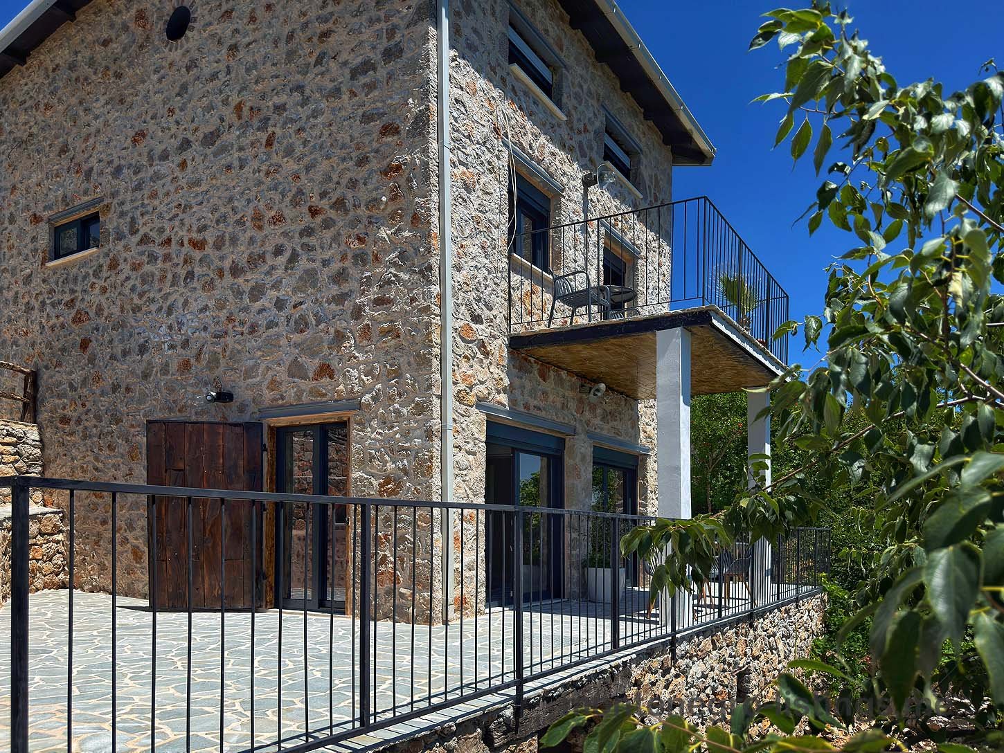 Elegant two-story stone house in Ulcinj, Montenegro&mdash;spacious balcony, glass doors, tiled patio. Exclusive on immorenta.me, a project by ekosphere doo.