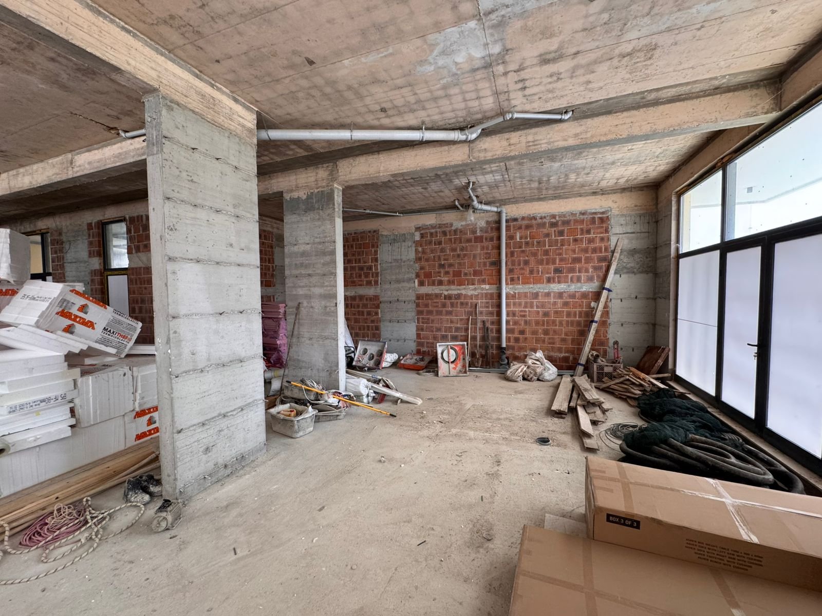 Spacious unfinished property in Ulcinj, Montenegro&mdash;concrete floors, exposed brick, large windows&mdash;ideal real estate investment. Featured on immorenta.me by Ekosphere doo.