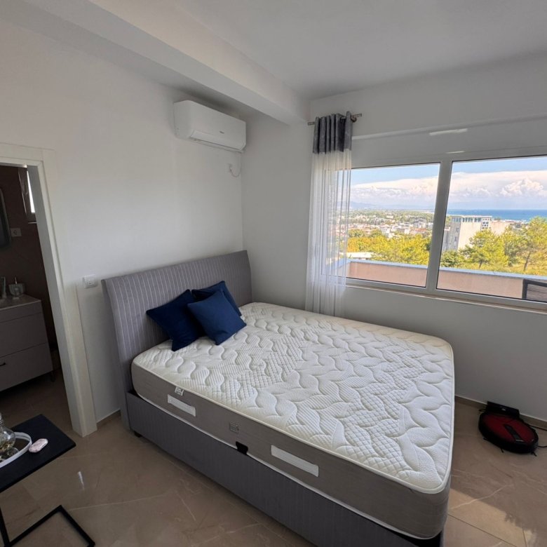 Bright Ulcinj bedroom with large window, sea and city views, ensuite bath. Premium investment at immorenta.me by ekosphere doo.