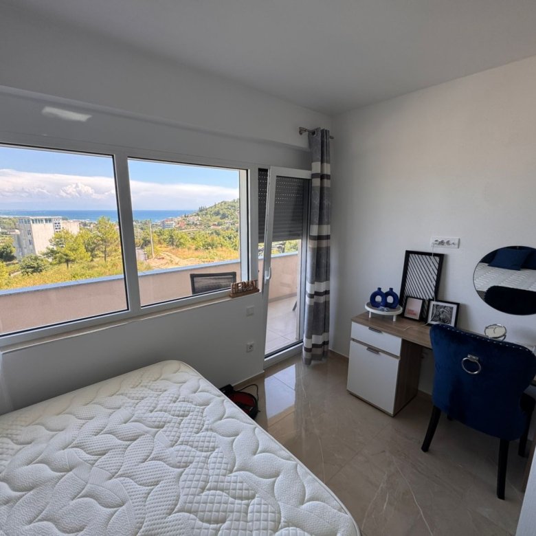 Modern Ulcinj bedroom with sea view, balcony, stylish desk and airy Ekosphere design&mdash;exclusive on immorenta.me property portal.