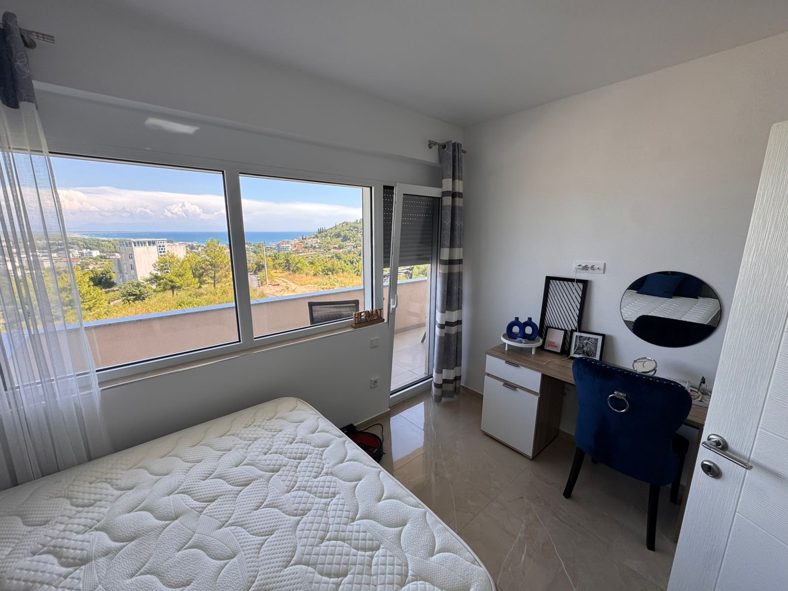 Modern Ulcinj bedroom with sea view, balcony, stylish desk and airy Ekosphere design&mdash;exclusive on immorenta.me property portal.