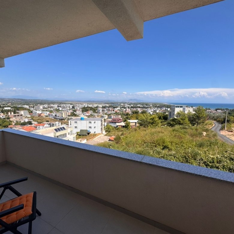 Premium Ulcinj Montenegro property: balcony with lush views, coastline, stylish seating. Top investment via immorenta.me/Ekosphere.