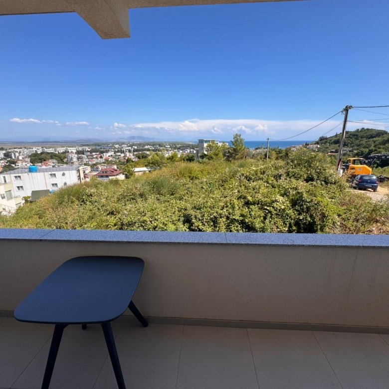 Stylish Ulcinj balcony with black table, green views, blue skies, cityscape&mdash;prime real estate via immorenta.me by ekosphere doo.