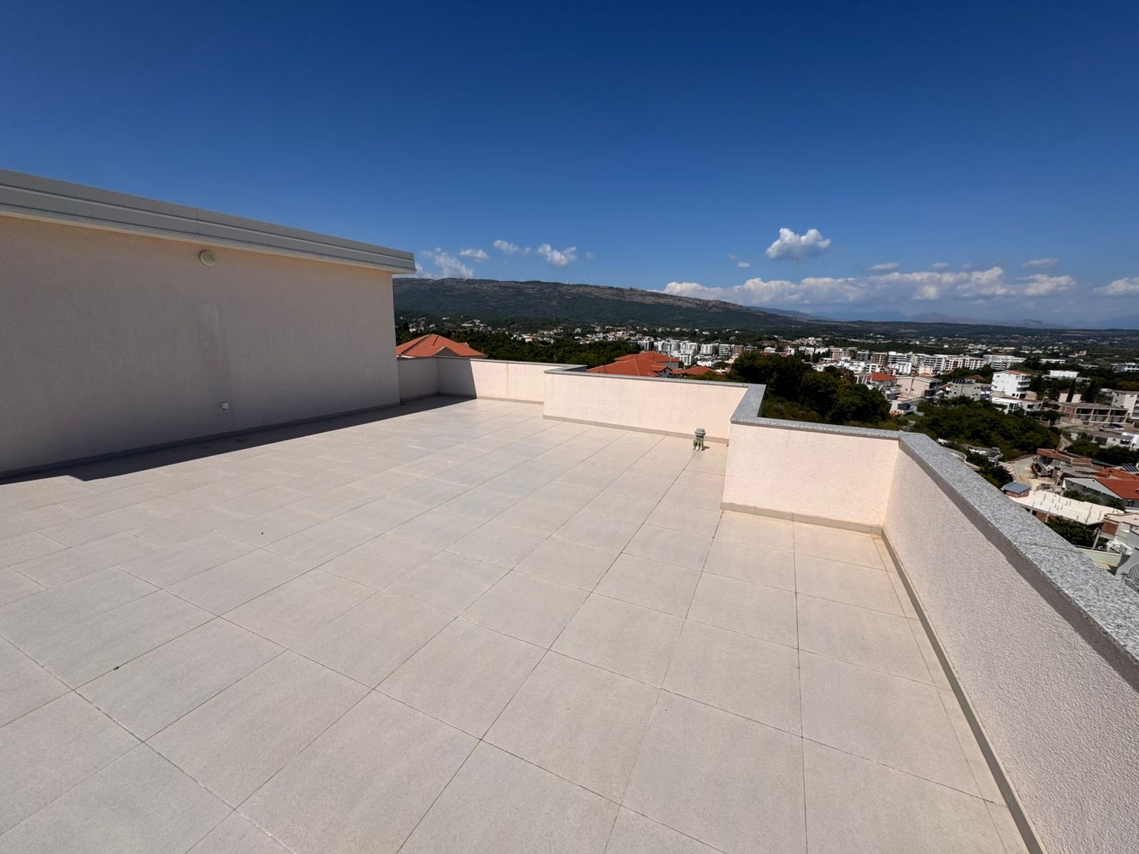 Expansive tiled rooftop terrace with panoramic Ulcinj views&mdash;ideal Montenegro real estate from Ekosphere doo at immorenta.me.