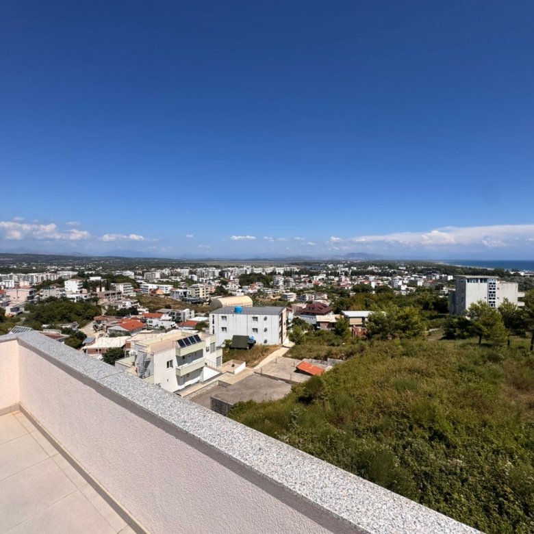 Stunning balcony view in Ulcinj, Montenegro: low-rise homes, lush greenery, sea horizon. Exclusive with immorenta.me by ekosphere doo.