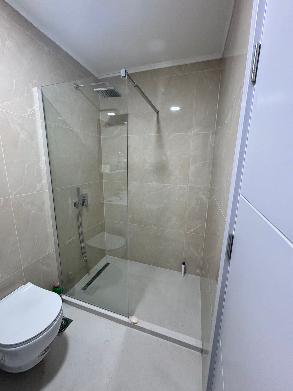 Elegant modern bathroom in Ulcinj, Montenegro with beige tiles, walk-in shower, premium fixtures. Exclusively at immorenta.me.