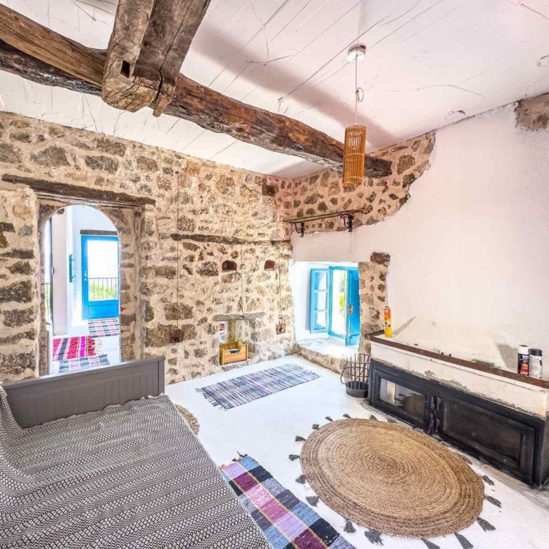Charming Ulcinj stone home: exposed beams, cozy fireplace, arched doorway. Invest in Montenegro real estate with immorenta.me.
