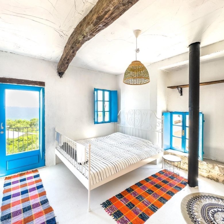 Listings for Sale - Spacious Ulcinj bedroom with white walls, blue windows, double bed, stove & lush views. Rare Montenegro investment&mdash;see immorenta.me by ekosphere doo.