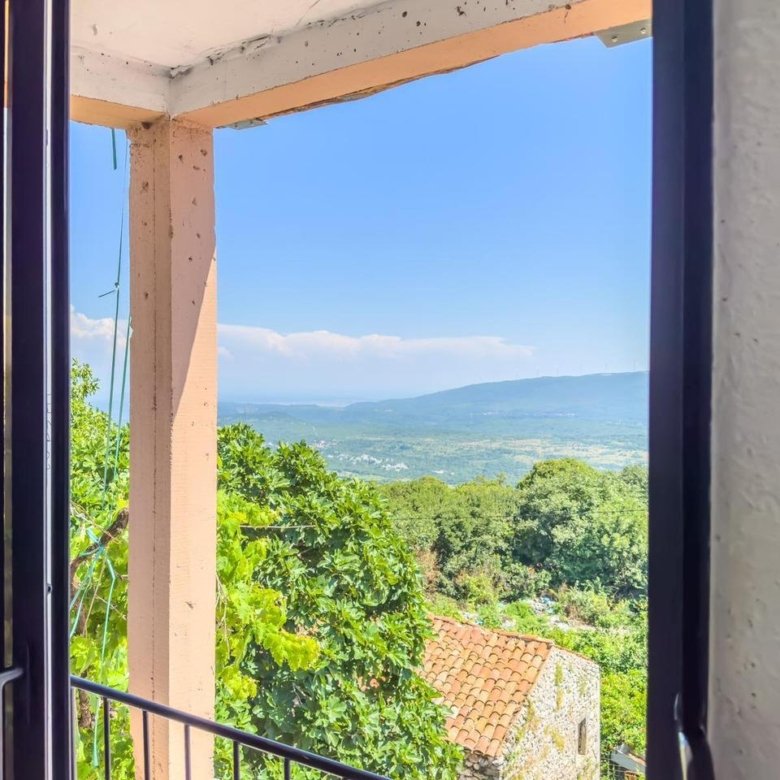 Stunning Ulcinj Montenegro property: balcony with scenic views of lush greenery, red-tiled roof, rolling hills & blue sky. Invest now&mdash;immorenta.me by ekosphere doo.