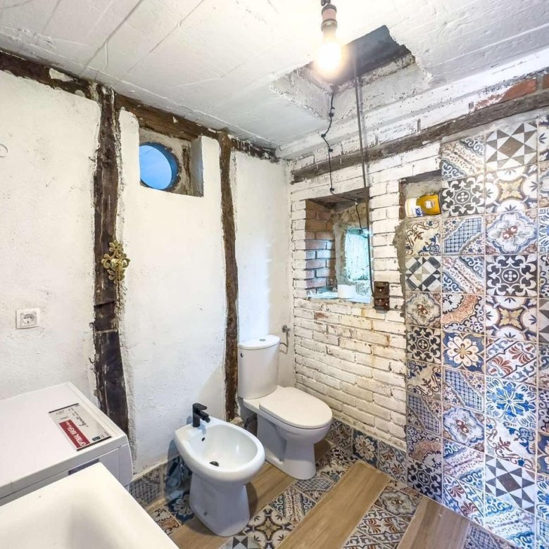 Modern bathroom in Ulcinj with exposed brick, wood beams, washer; ideal investment. Montenegro-listings.me by ekosphere doo.
