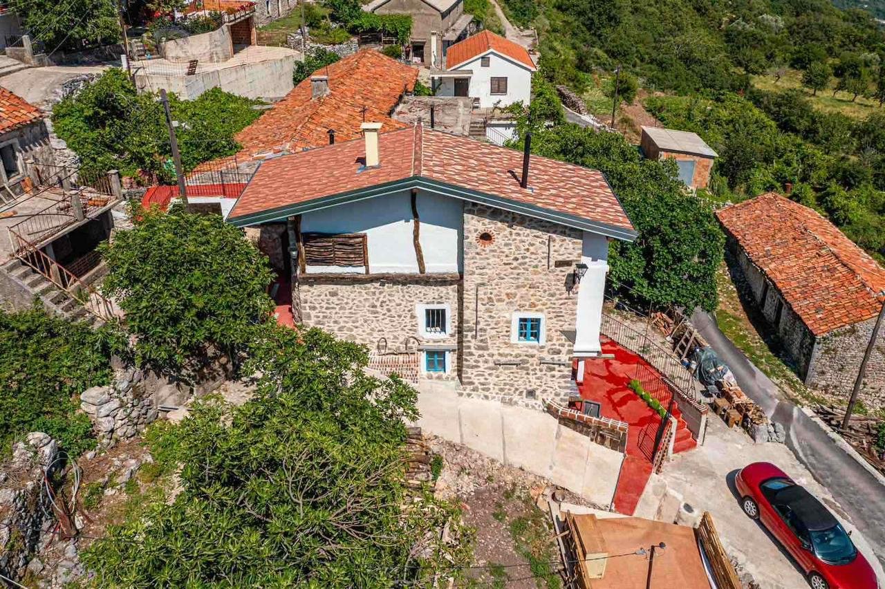 Ulcinj Real Estate Discover a traditional stone house with red-tiled roof in hilly, green Ulcinj&mdash;prime real estate on immorenta.me by ekosphere doo.