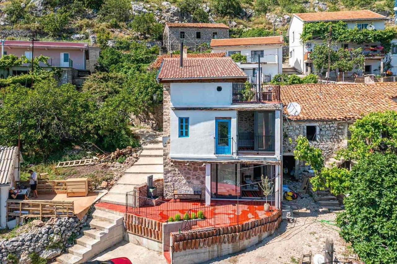 Stunning two-story stone house in Ulcinj with red-tiled roof, blue accents, lush yard, patio&mdash;exclusive at immorenta.me by ekosphere doo.