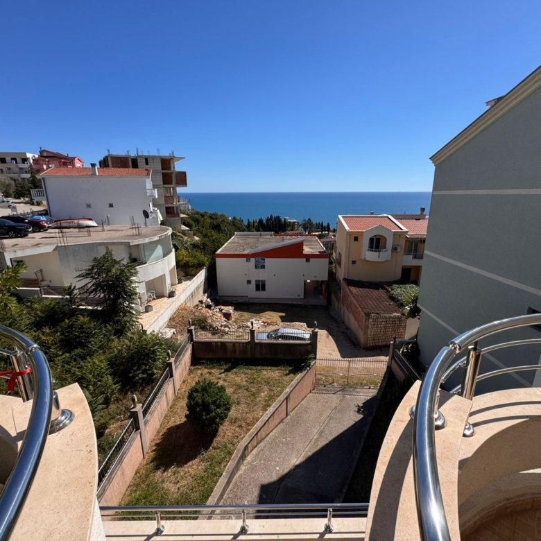 Stunning Ulcinj balcony view: peaceful homes, lush greenery, road to blue sea. Prime Montenegro real estate by ekosphere doo.