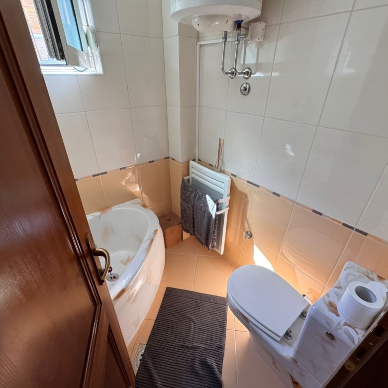 Contemporary Ulcinj bathroom with corner tub, window lighting, modern fittings; invest in Montenegro at immorenta.me by ekosphere doo.