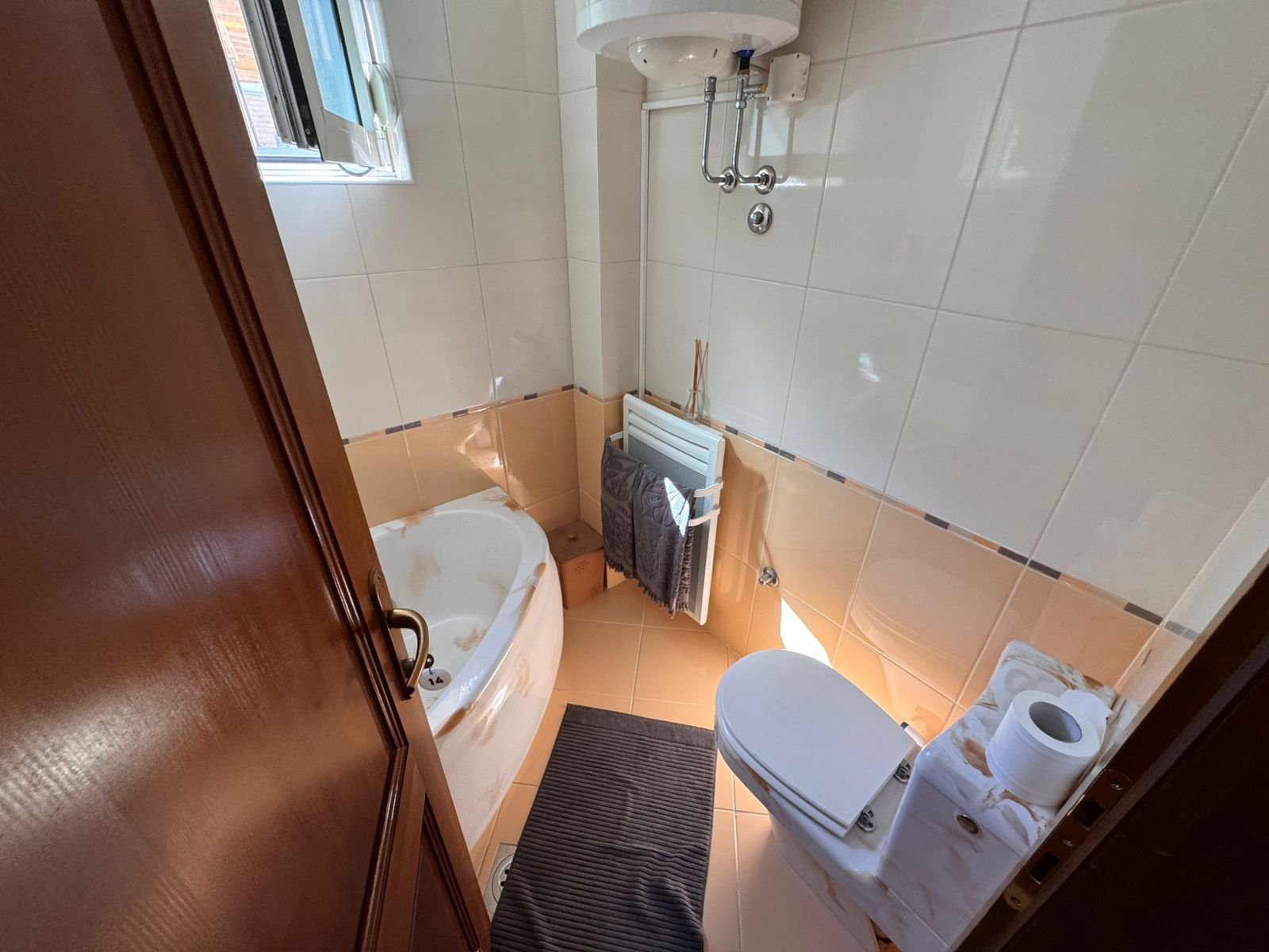 Contemporary Ulcinj bathroom with corner tub, window lighting, modern fittings; invest in Montenegro at immorenta.me by ekosphere doo.