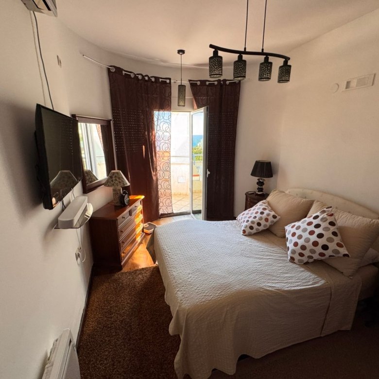 Sunlit Ulcinj bedroom: double bed, modern decor, balcony access&mdash;premium Montenegro property. Exclusive at immorenta.me by ekosphere doo.