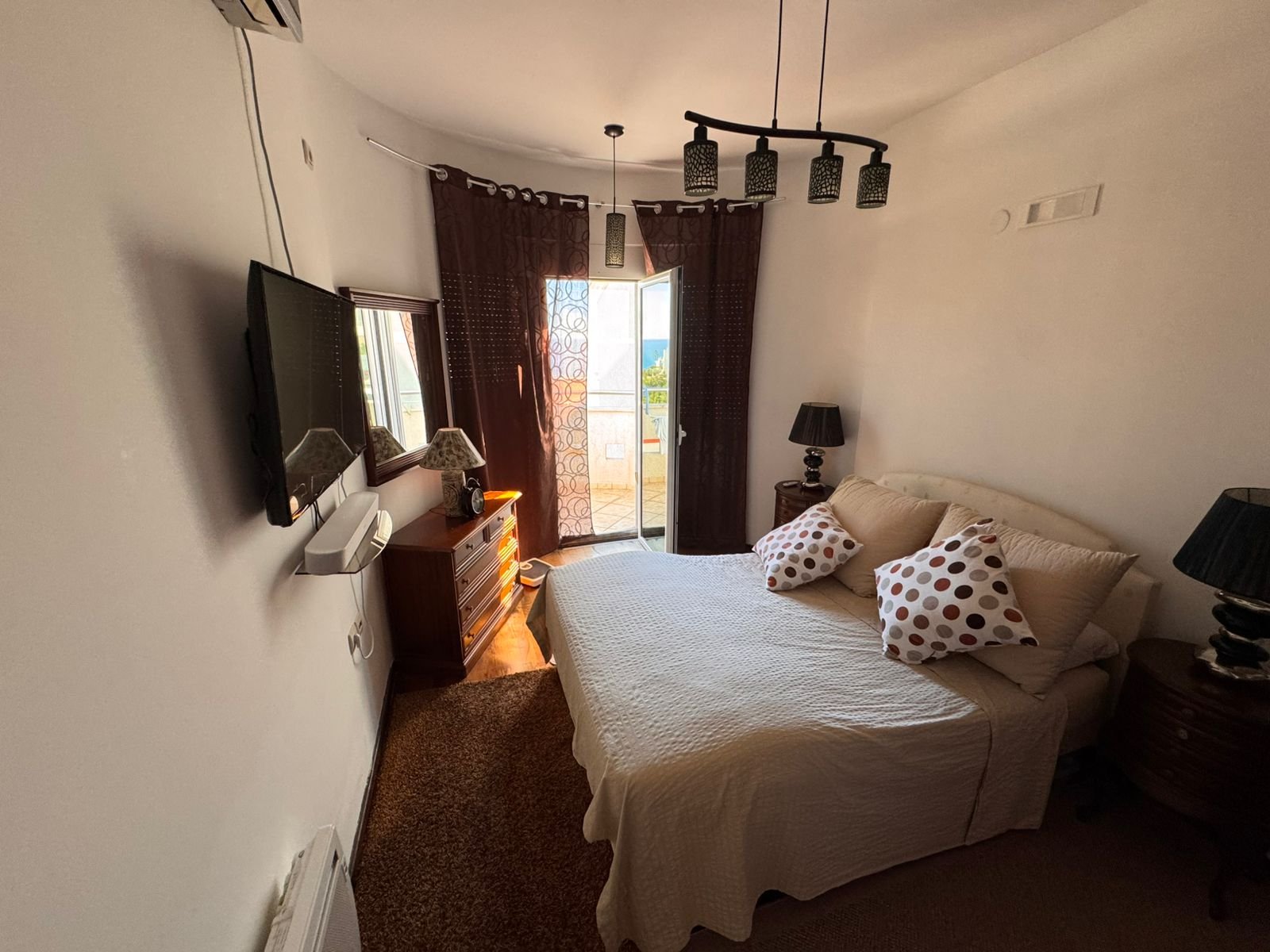 Sunlit Ulcinj bedroom: double bed, modern decor, balcony access&mdash;premium Montenegro property. Exclusive at immorenta.me by ekosphere doo.