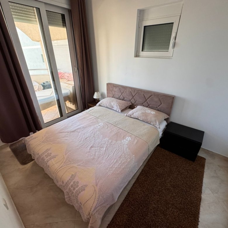 Bright Ulcinj bedroom with a double bed, modern decor, ample natural light&mdash;exclusive real estate at immorenta.me by ekosphere doo.