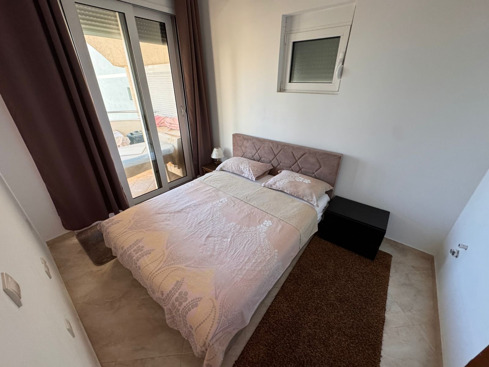 Bright Ulcinj bedroom with a double bed, modern decor, ample natural light&mdash;exclusive real estate at immorenta.me by ekosphere doo.