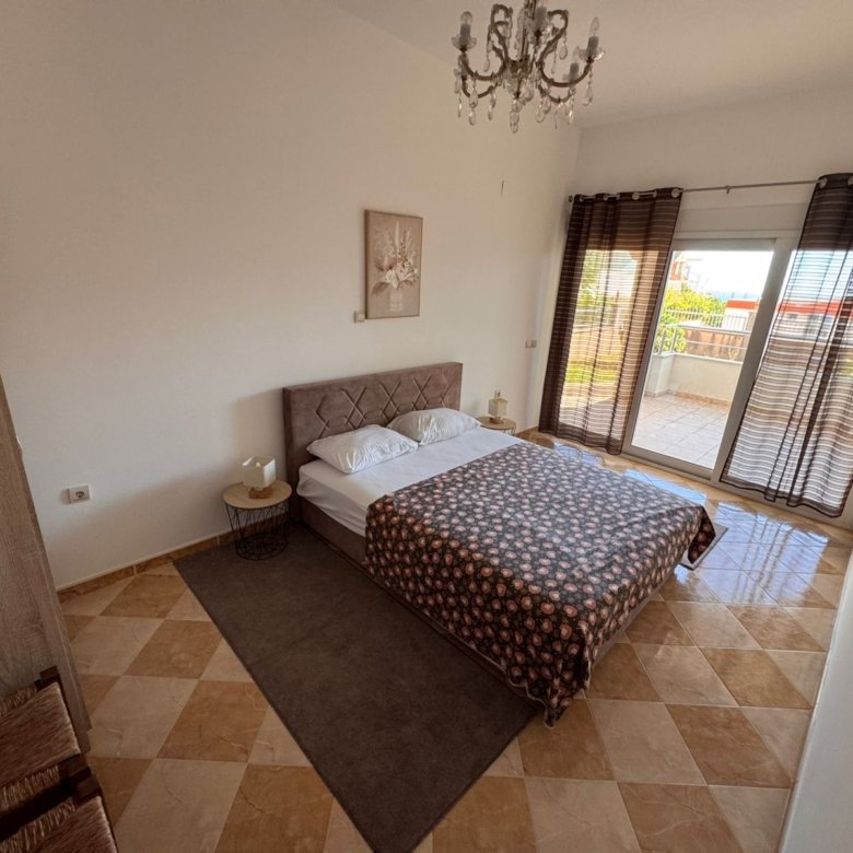 Elegant Ulcinj bedroom: double bed, nightstands, chandelier, checkered floors, balcony with views&mdash;exclusive at immorenta.me by ekosphere doo.